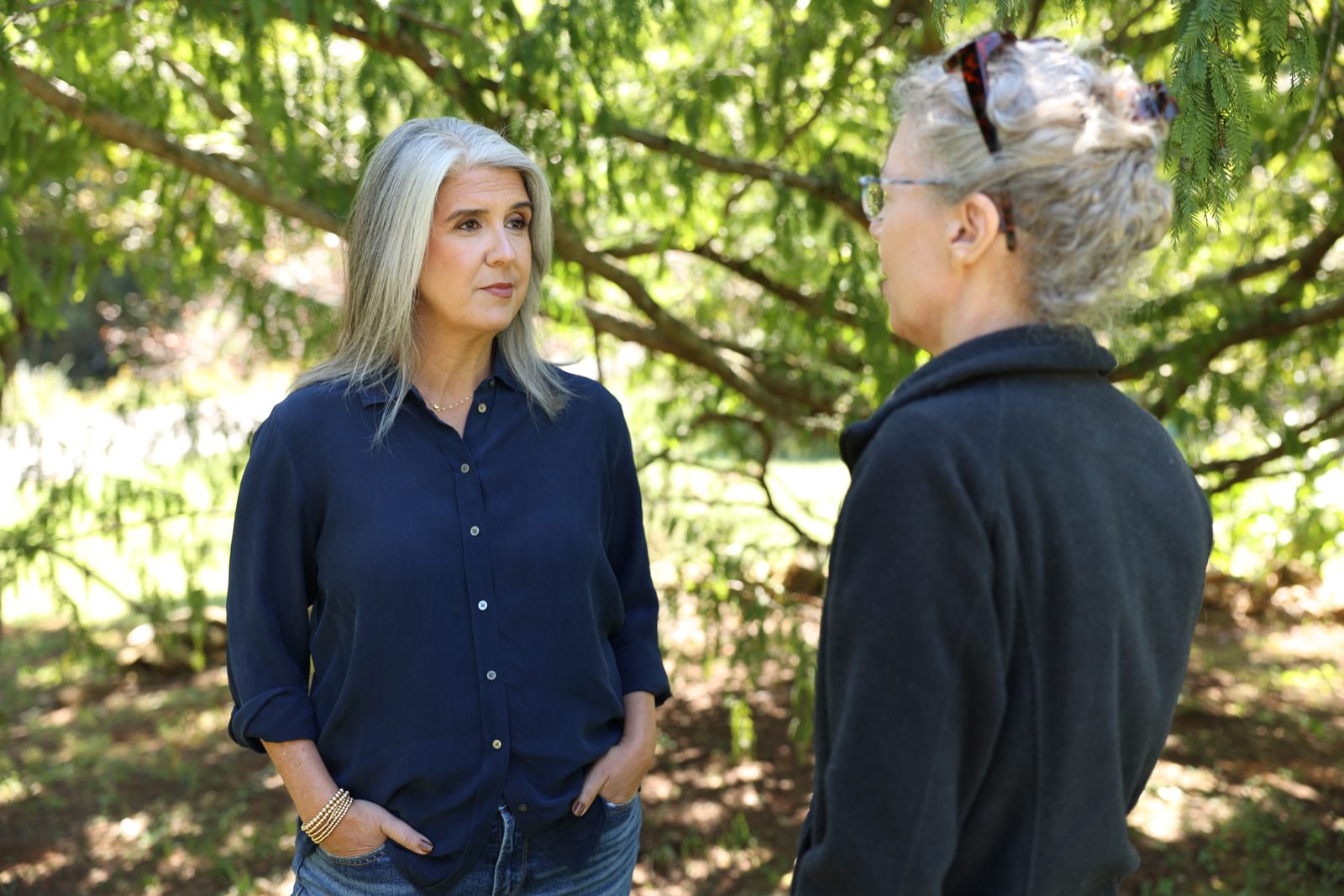 April Montgomery listening to a neighbor in a garden.